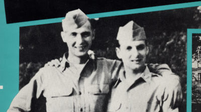 Two smiling men in army uniforms have their arms around each others shoulders in an old black and white image.