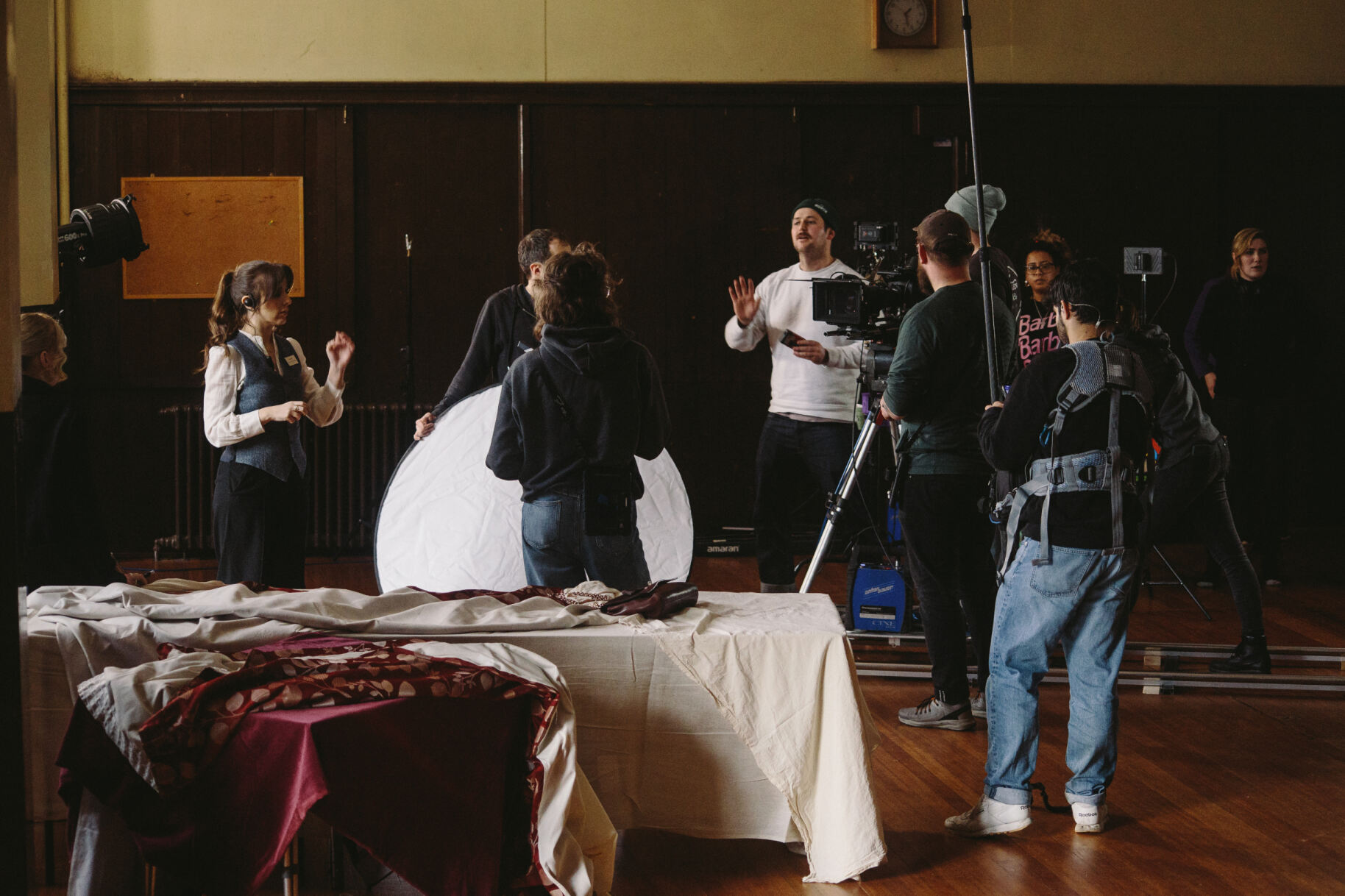 Busy film set with equipment, crew, and props.