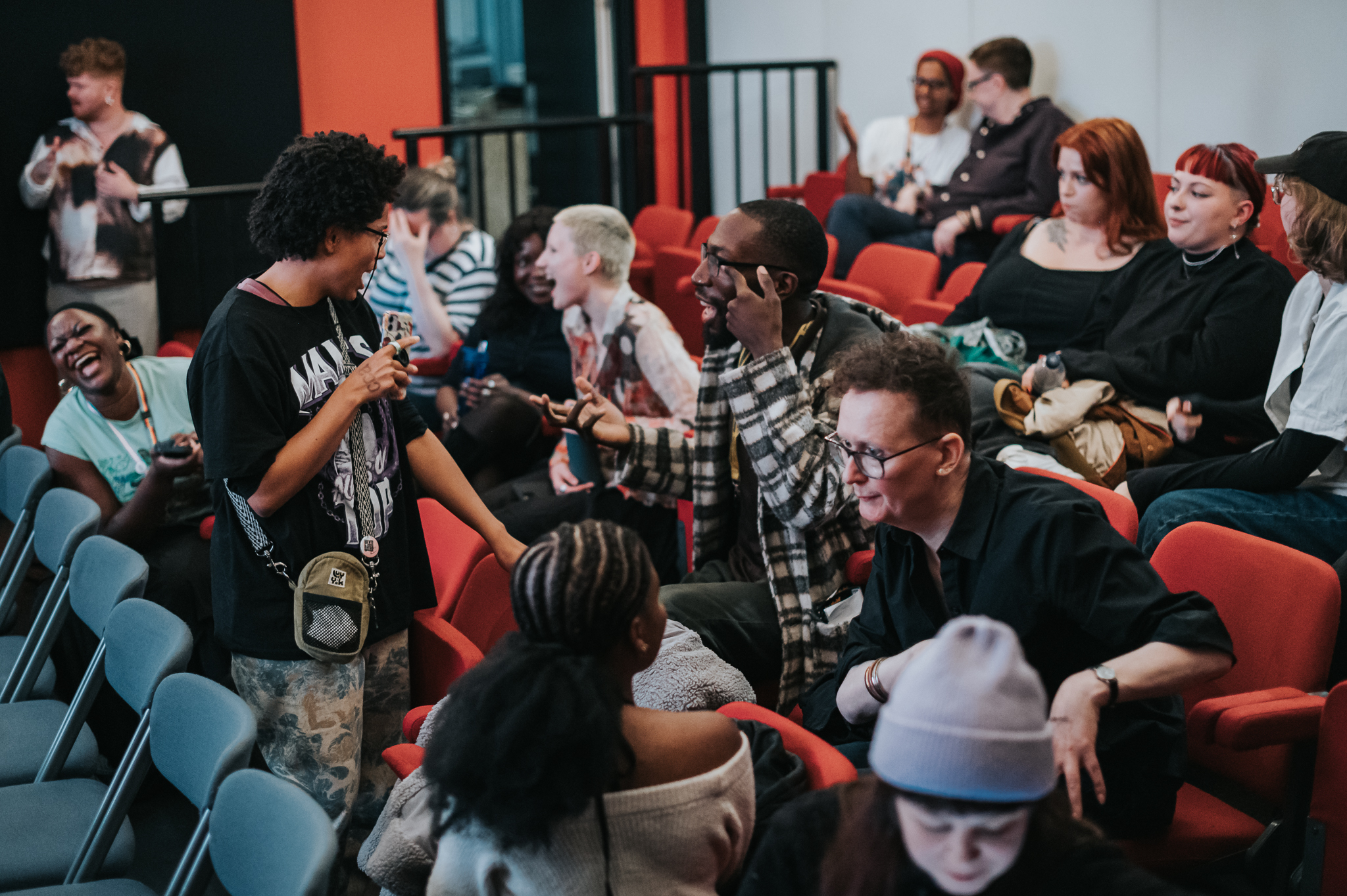 Loads of queer filmmakers networking in a cinema space.