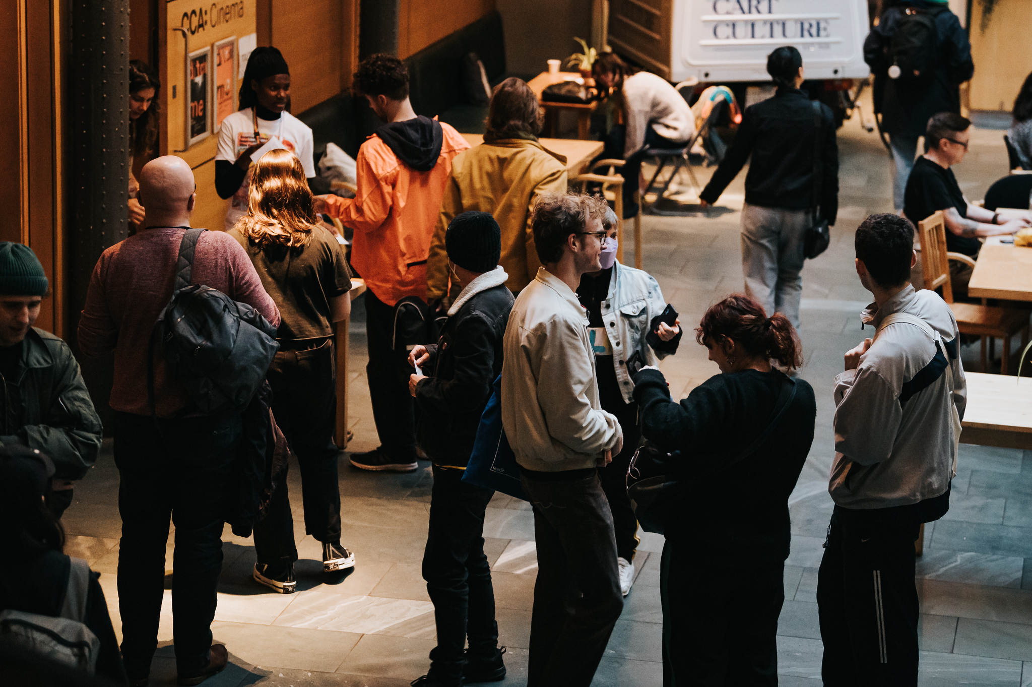 Various people socialising in an open space.